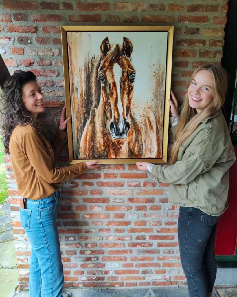 A client receiving the finished portrait of her late horse Parino